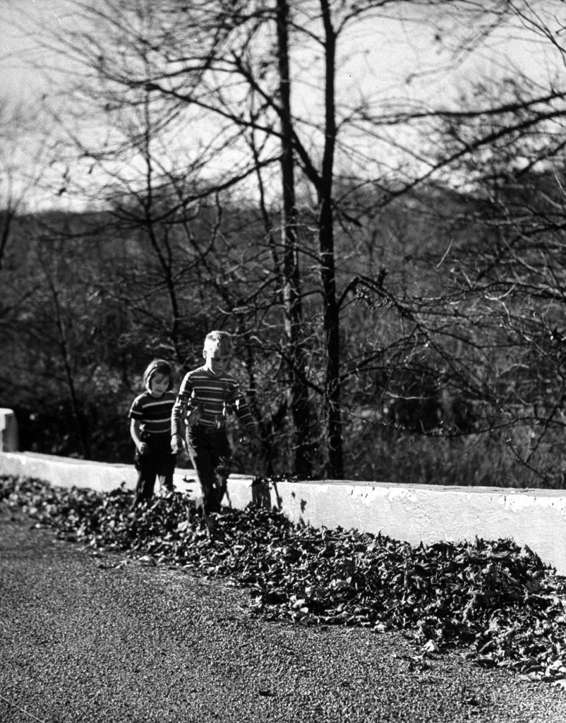 Dragging their feet, Raymond Burghardt and Ellen Bassett scuff through a window blown against a fence.