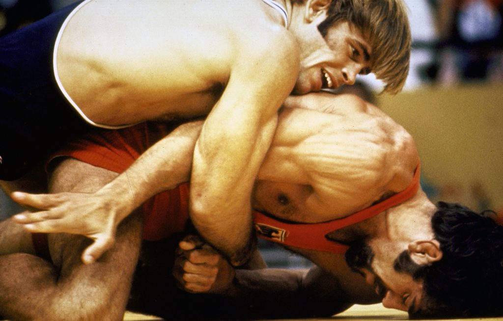US wrestler eventual gold medal winner Wayne Wells (top) overpowering W. German Adolf Seger in freestyle welterweight elimination match at the 1972 summer Olympics in Munich, West Germany.